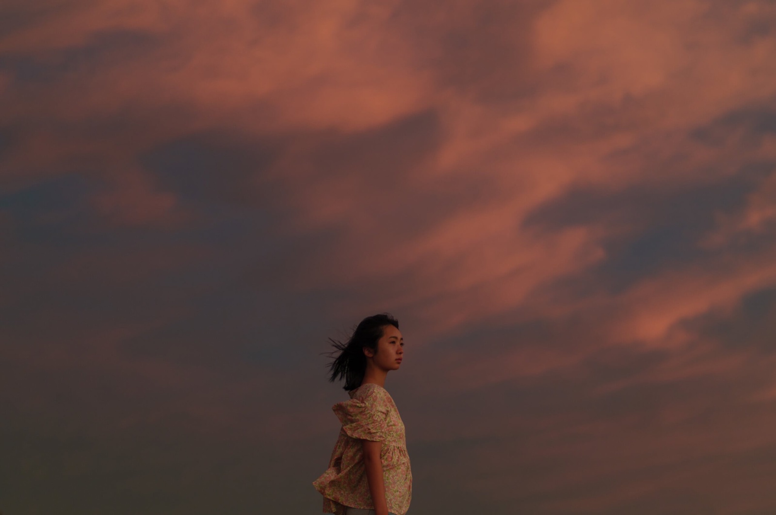 노을을 배경으로 선 여성